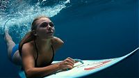 Sport and Fitness: young surfing girl