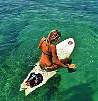 Sport and Fitness: young surfing girl