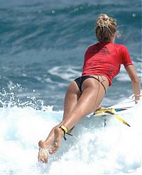 Sport and Fitness: young surfing girl