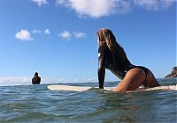 Sport and Fitness: young surfing girl