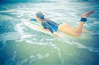 Sport and Fitness: young surfing girl