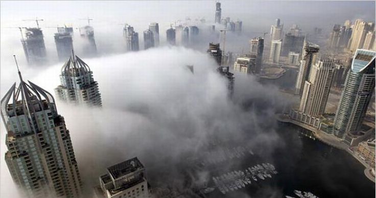 bird's-eye view of buildings above the clouds