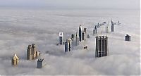 bird's-eye view of buildings above the clouds