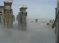 World & Travel: bird's-eye view of buildings above the clouds