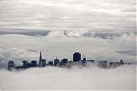 World & Travel: bird's-eye view of buildings above the clouds
