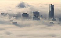 World & Travel: bird's-eye view of buildings above the clouds