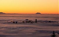 World & Travel: bird's-eye view of buildings above the clouds