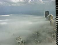 World & Travel: bird's-eye view of buildings above the clouds