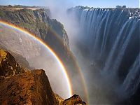 World & Travel: Rainbow over Victoria Falls, Zambezi River, Africa