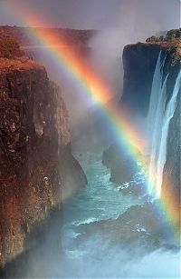 World & Travel: Rainbow over Victoria Falls, Zambezi River, Africa